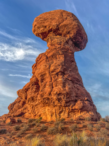 The large Balanced Rock is perched on its tower, bathing in the early morning sun.