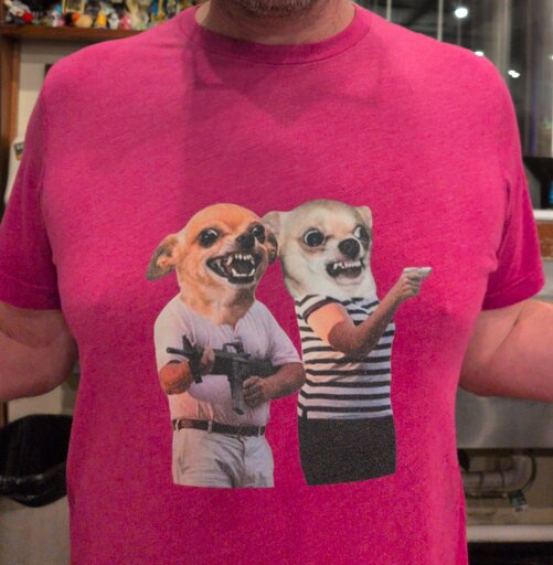 Pink shirt with two chihuahua-headed people wielding guns. Based on a wacky lawyer couple who pointed guns at protestors.