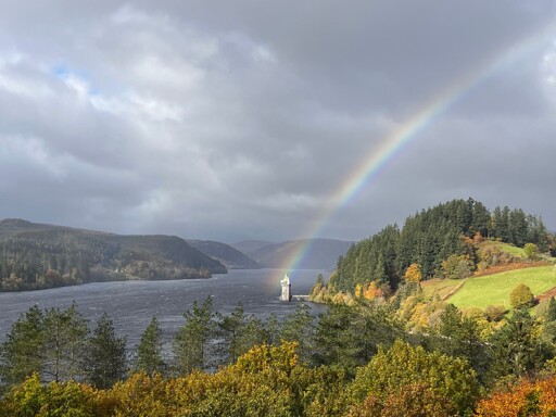 A rainbow landing on the straining tower in the middle of Lake Vyrnwy